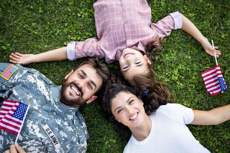 Featured image for Morale, Welfare, and Recreation programs – also called MWR programs – showing a happy military family lying on the grass