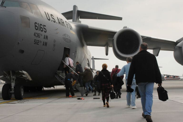 Featured image for Space-A Travel, showing military personnel, Veterans, and their families boarding a military Space-A flight