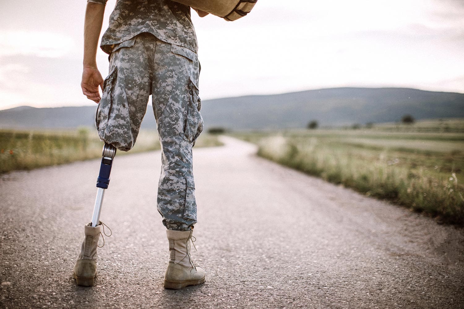 Featured image for VA Disability, showing a disabled Veteran standing on a road